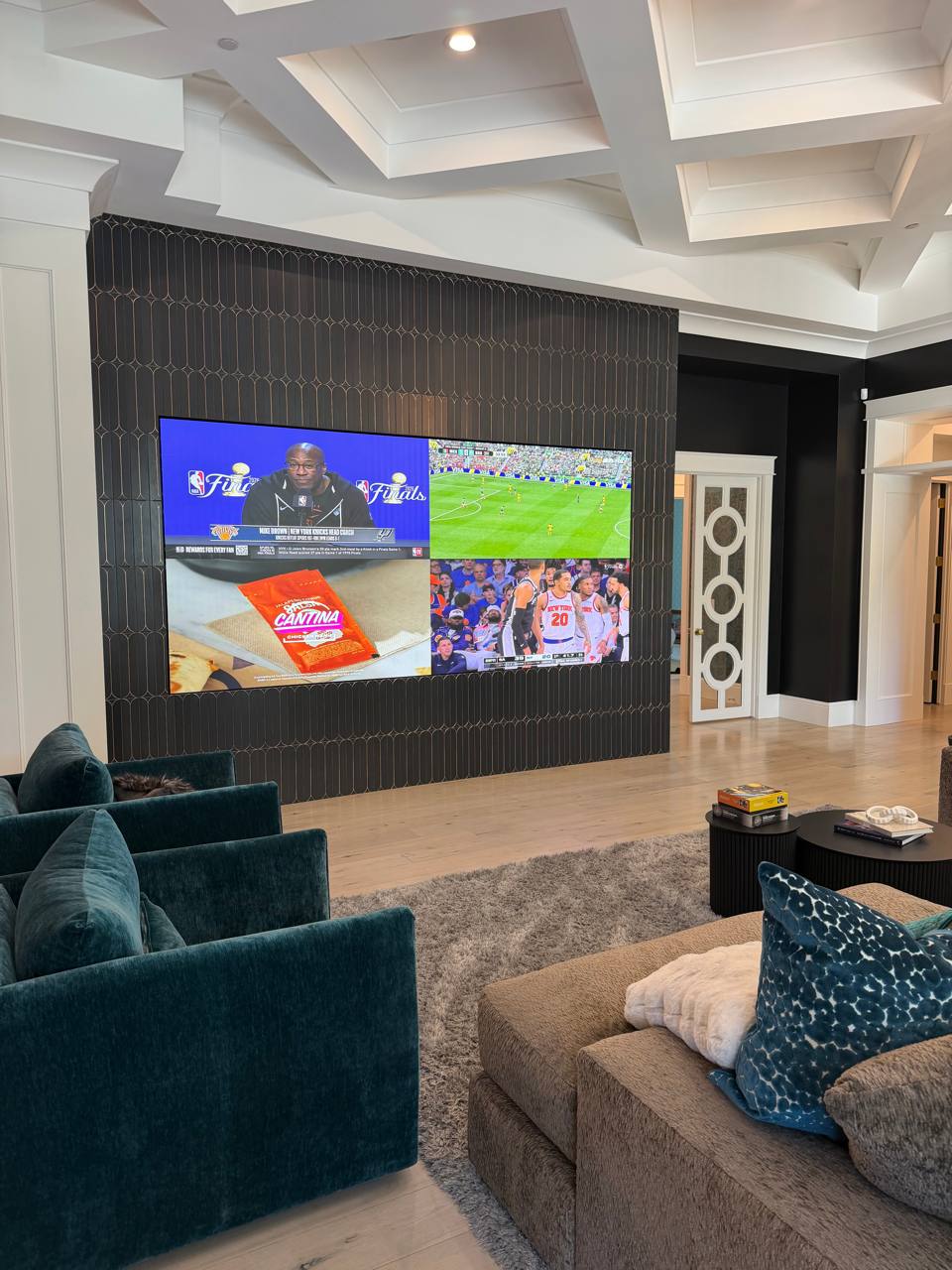 The same feature wall revealed, showing a four-way sports broadcast on the video wall