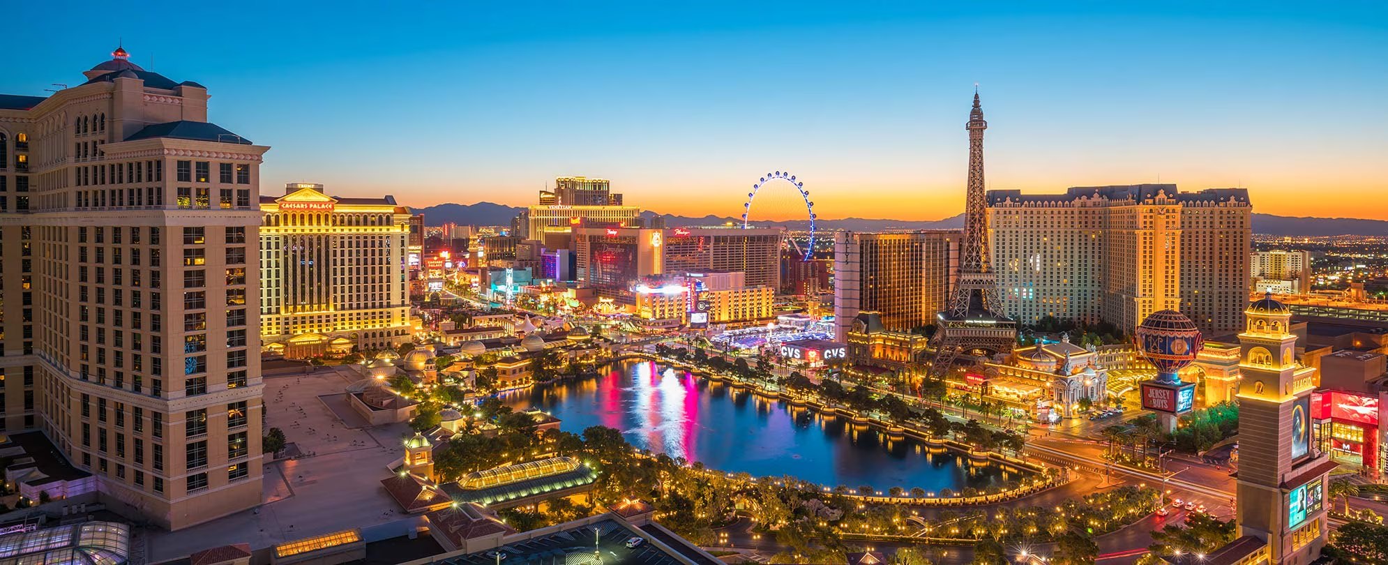 The Las Vegas Strip at night — Bellagio fountains, Eiffel Tower, and High Roller
