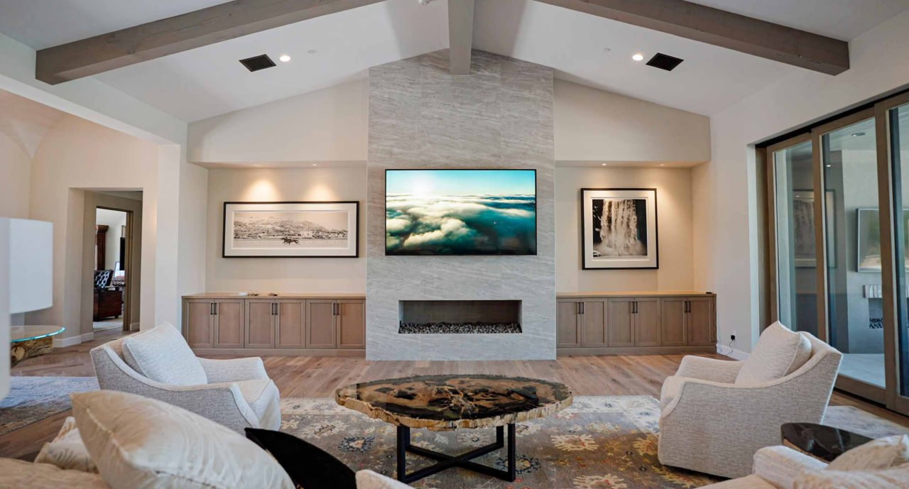 Beyond Audio great-room display blended into the room in art mode above the linear fireplace